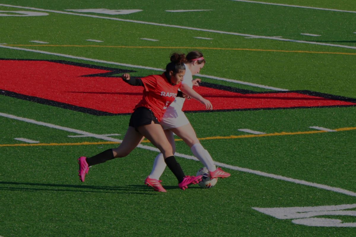 Freshman Darcy Antunez puts pressure on a defender from Broadway High School and takes control of the ball after. 
