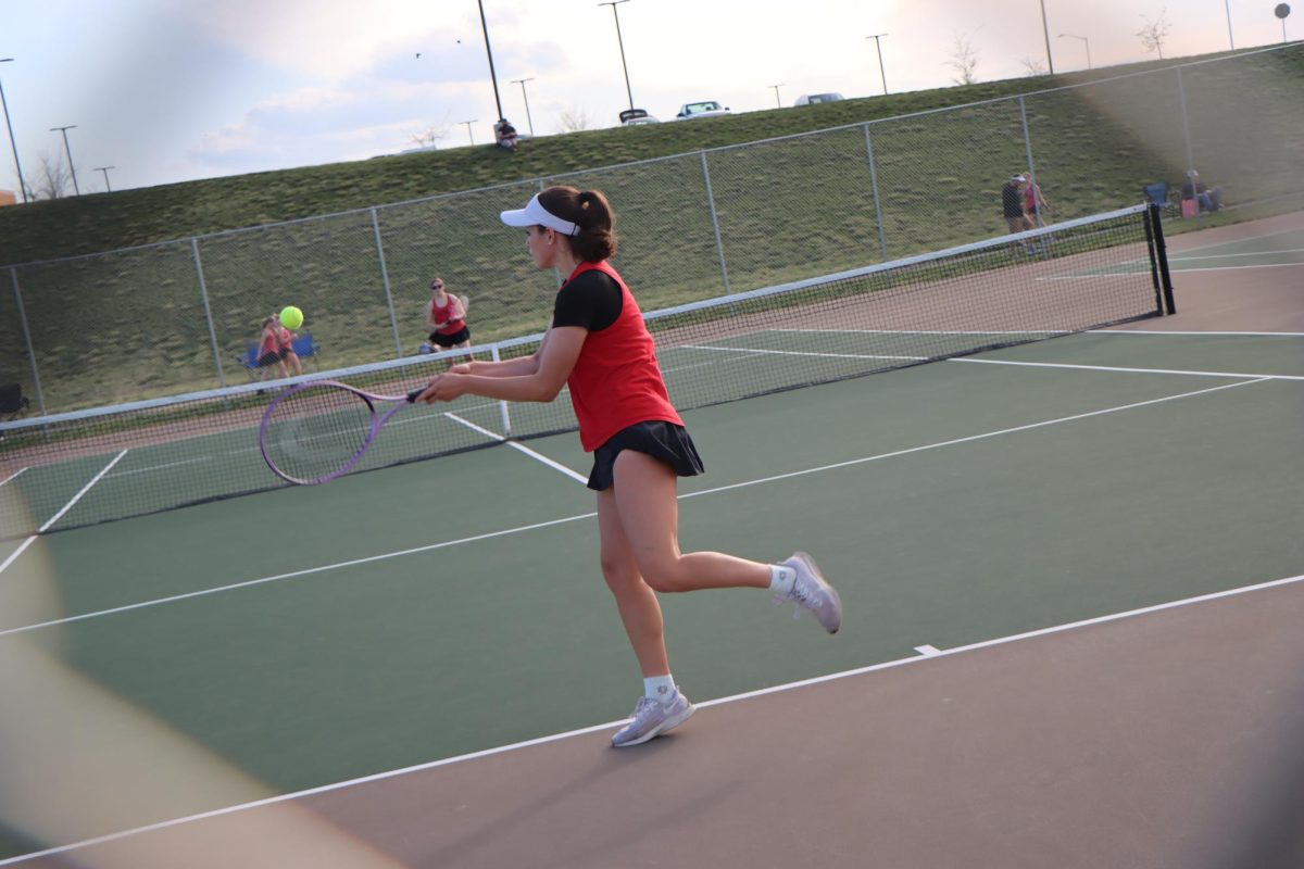 Taylor more hits a backhand shot during her singles match.
