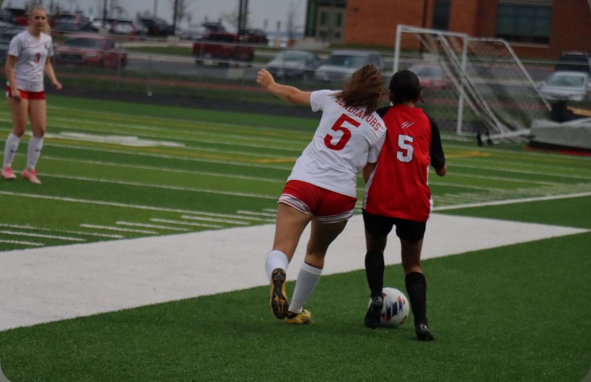 Sophomore Mia Mejia fights for the ball while her same number but different jersey puts pressure on her.