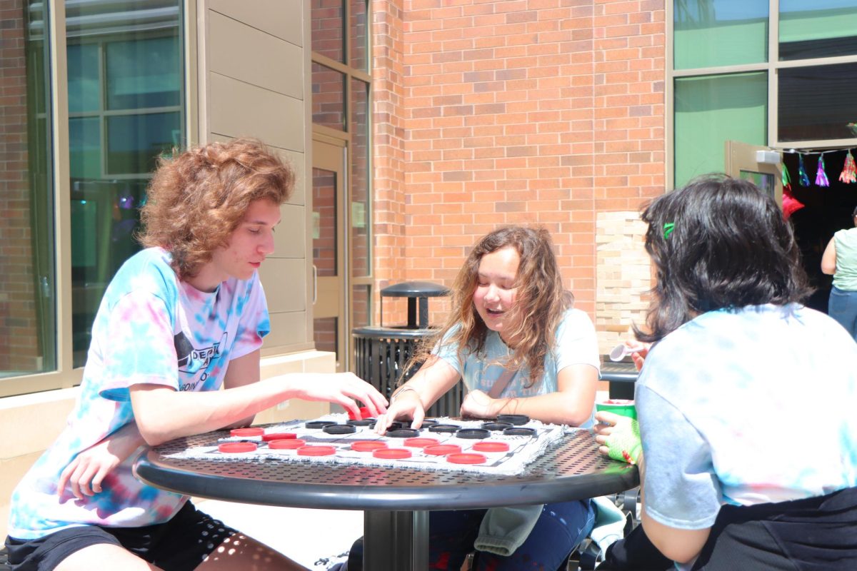 Senior Cleet Buddy challenges his friends to a match of checkers.  