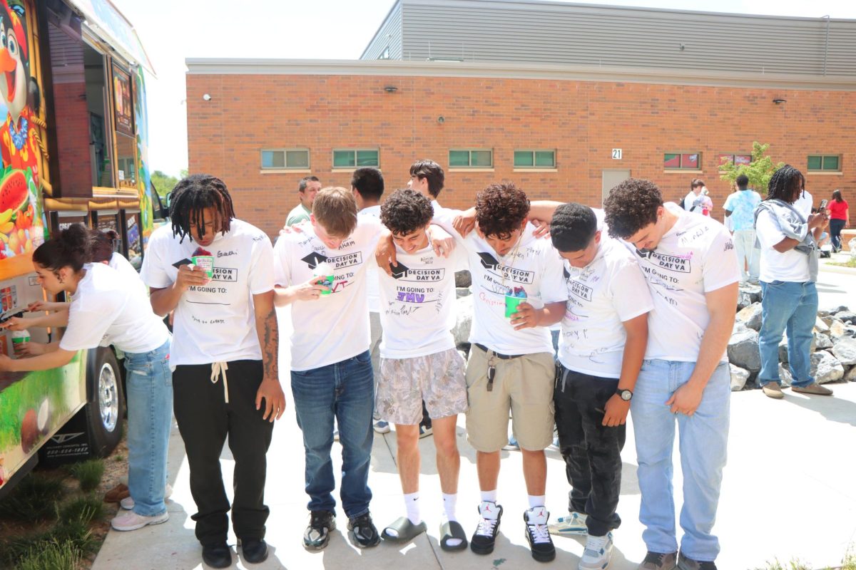 Seniors post up for one last group photo at decision day.