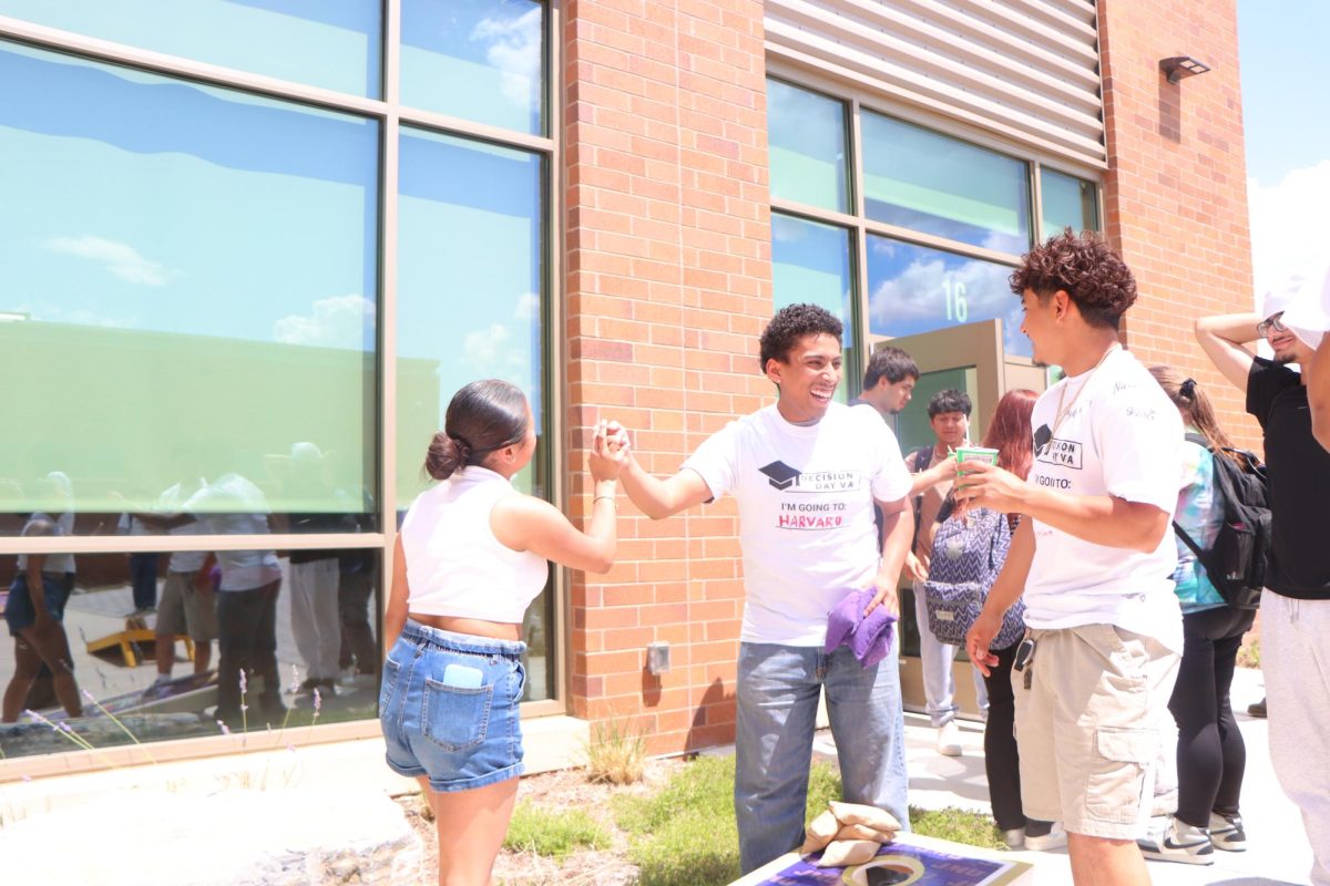 Alicia Lopez congratulates Alex Lopez on a nice cornhole shot.