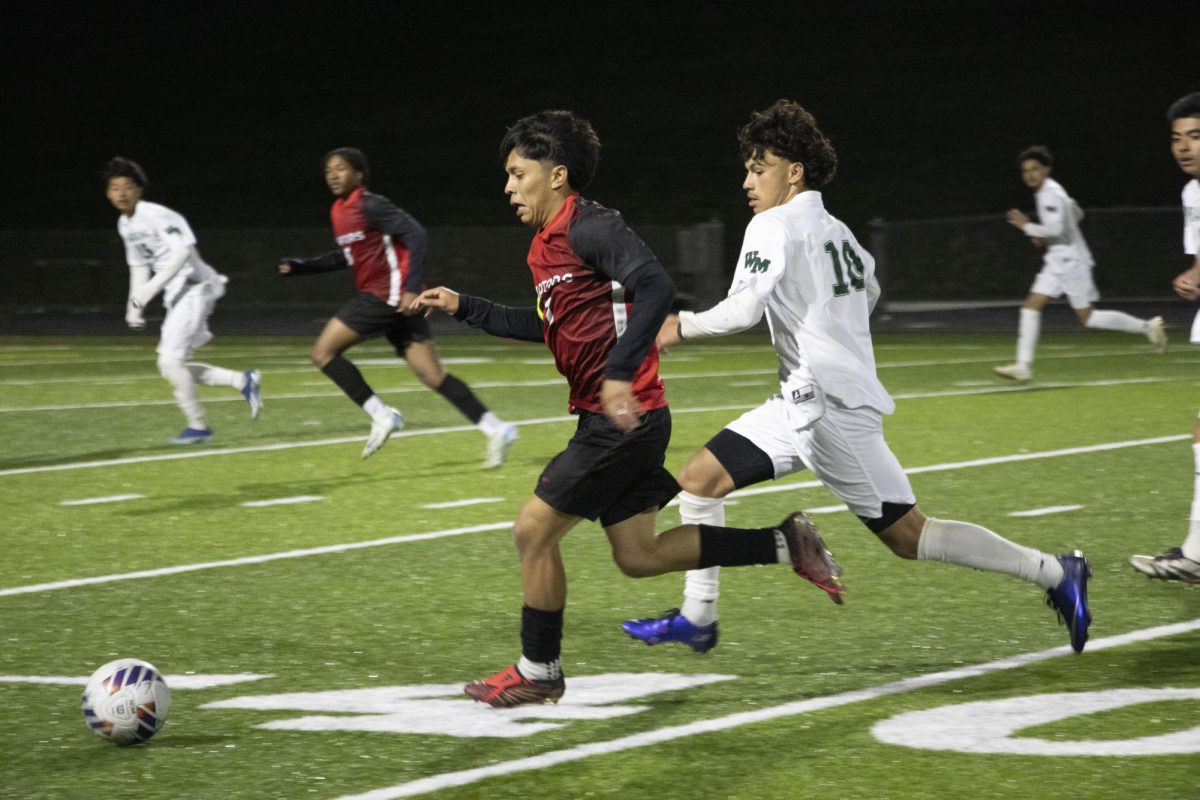Senior Antony Pereira runs with pressure near the ball.