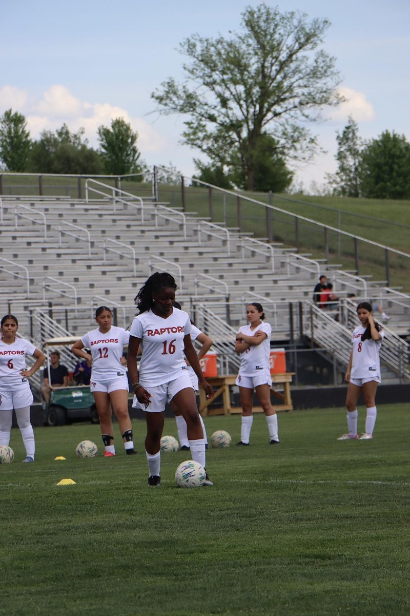 Kelly-Keziah Anye warming up with soccer ball before game.
