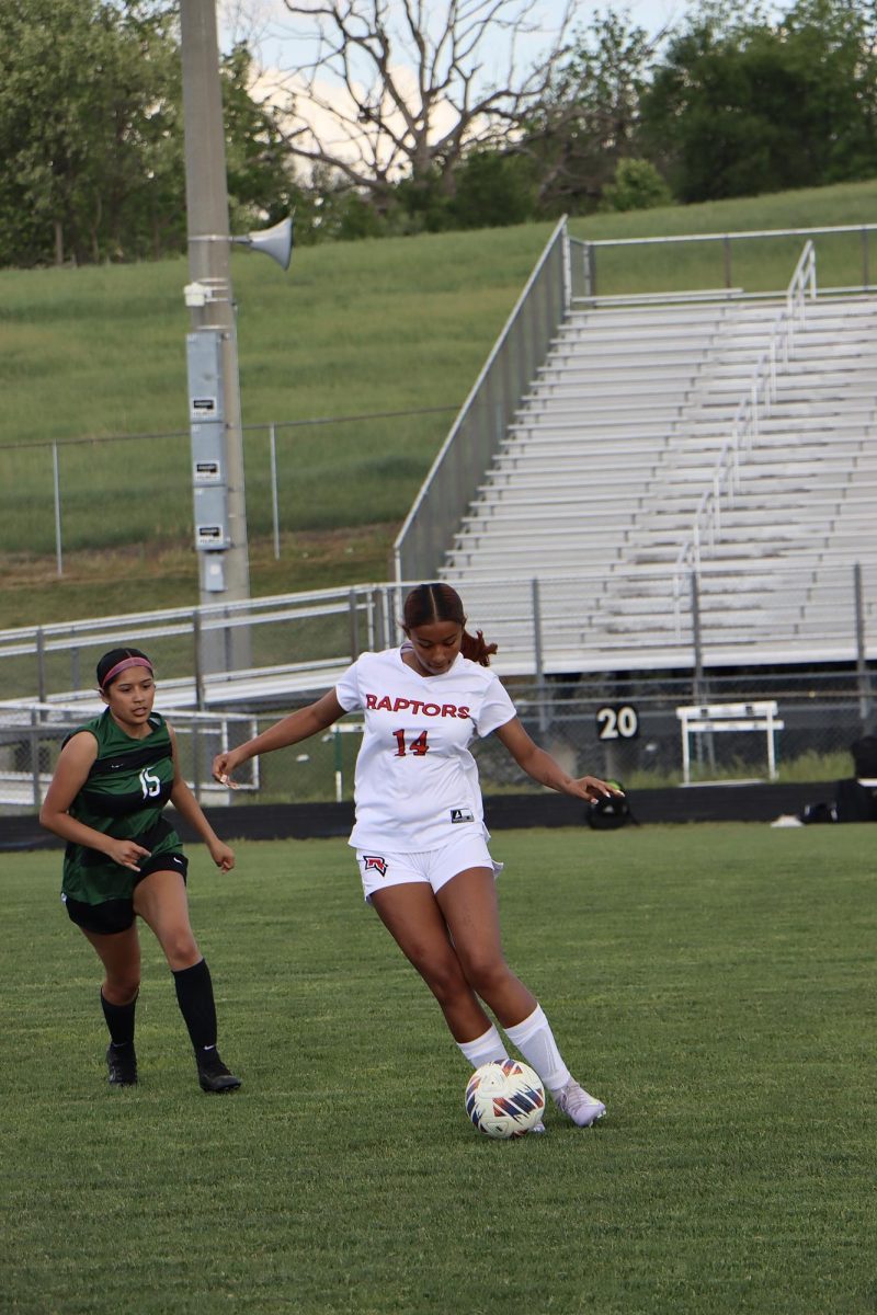 Emily Quinonez dribbles ball away from opponent.