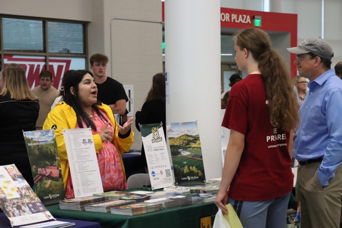  A student talks to a representative of Lee McRae college during college night.

