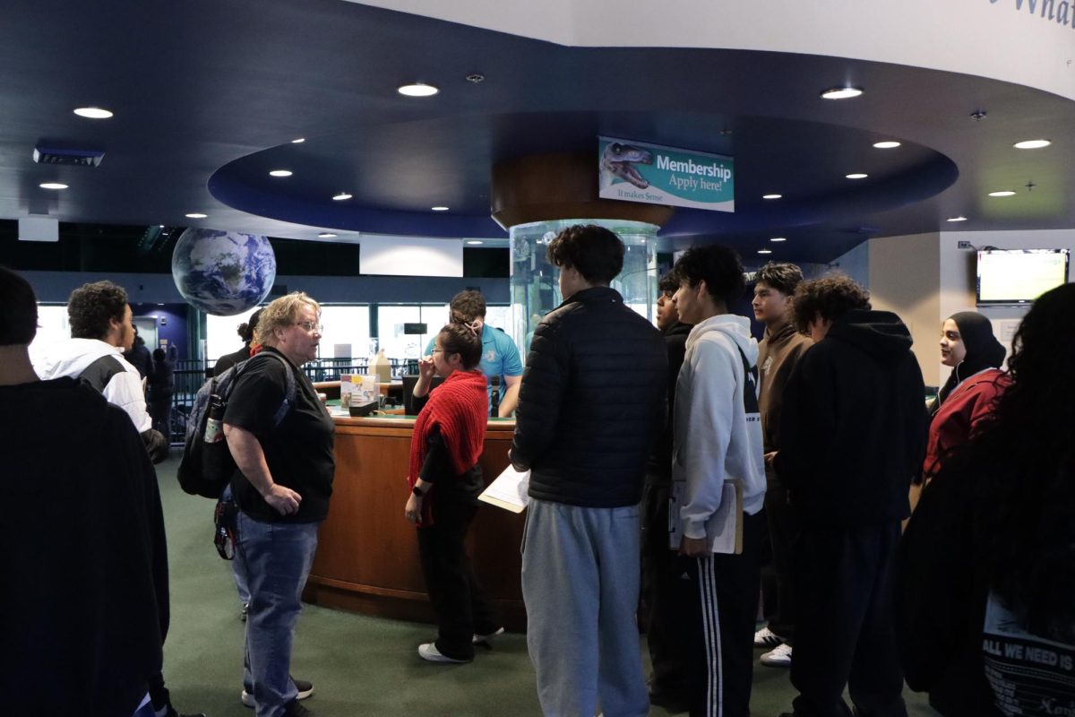 Students explore an aquarium before touring Christopher Newport University.