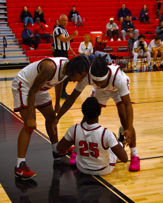 Ayden Grodon and Na'im Sampson celebrating with Dyrue Leach after he scores a 3pt to tie up the game