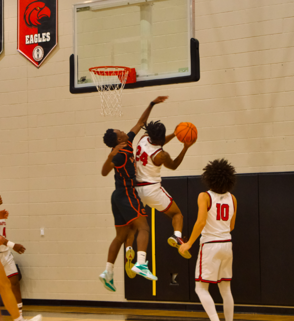 Ayden Grodon #24 going up for a layup against the opposing defender